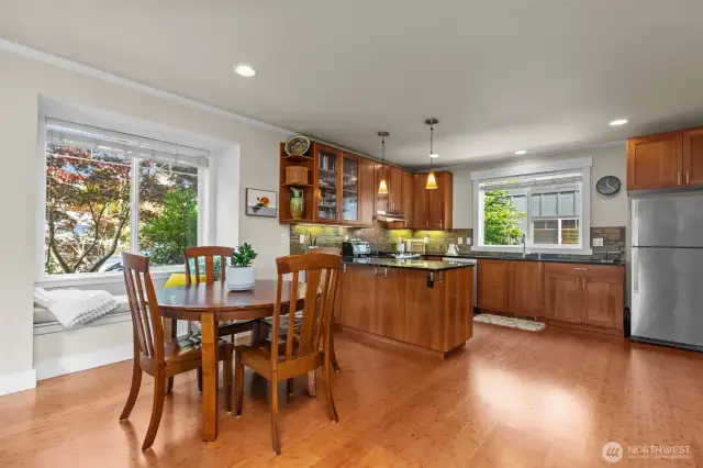 Dining area features sunny reading nook.