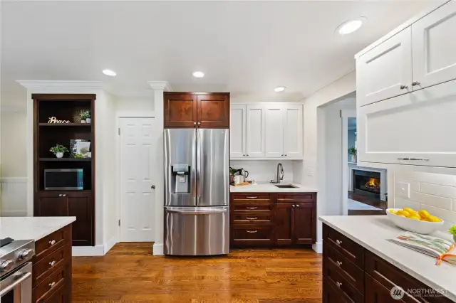 Walk-in Pantry, coffee station with utility sink, oak floors, stainless appliances and built-ins.