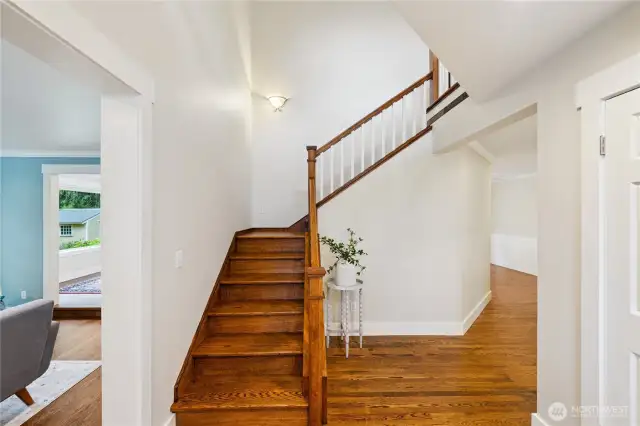Entry and stairway leads to primary suite, plus 2 more bedrooms, one full guest bathroom, generous utility room, and supersized family room!