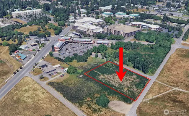 The red arrow and red line outlining the property line are superimposed onto this image.