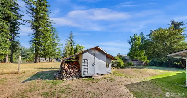Garden shed also has an awning for firewood storage!