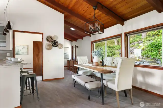 Dining area with kitchen at left, doorway to the den/family rm &, on the right, the hall with the bar/butler's pantry and on to the back door and back stairs to the walkout basement