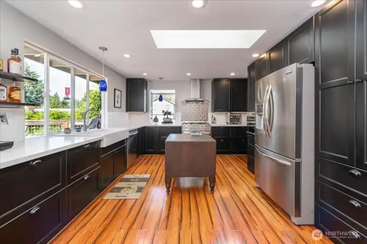 Custom Bamboo floors shine throughout the amazing chef's kitchen.
