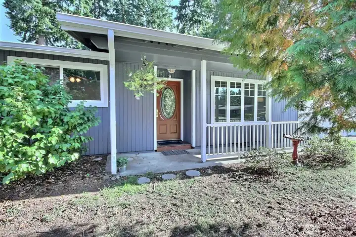 Front door and covered porch offer a cozy spot to relax and enjoy your morning coffee or greet neighbors!