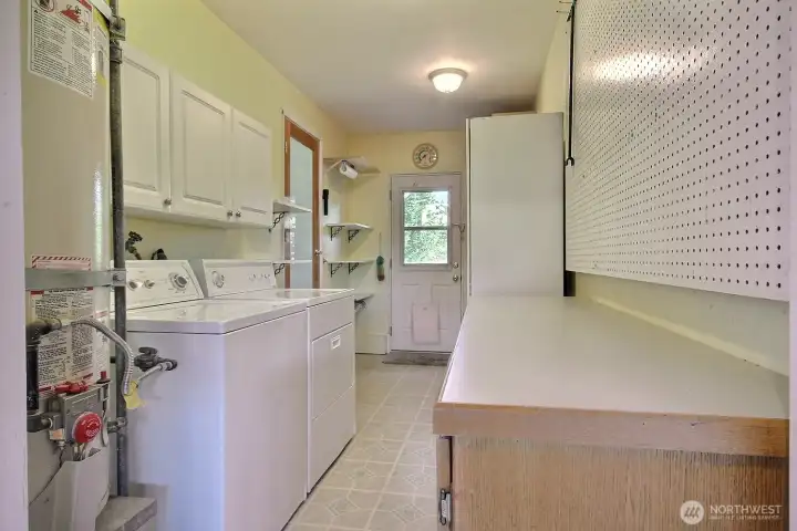 Laundry/Mud room designed for everyday tasks, offering additional storage with easy access to the garage and backyard.