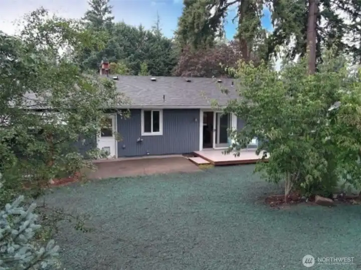 Enjoy a picture-perfect backyard featuring lush new grass and mature landscaping.