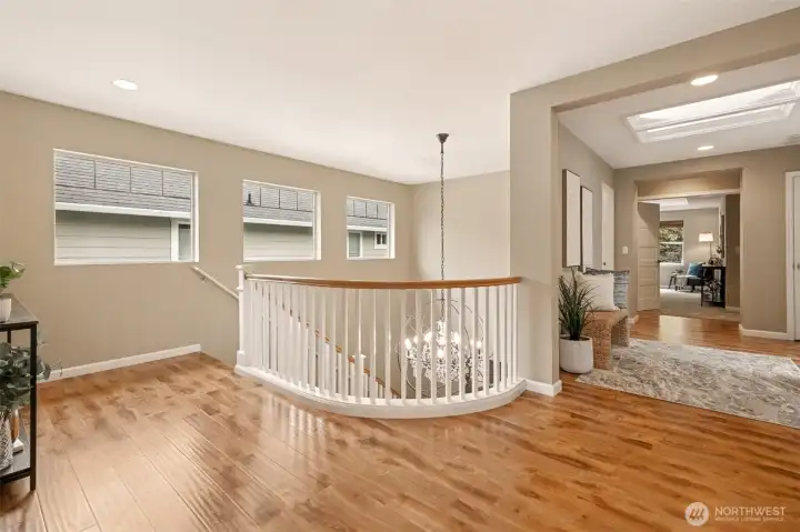 The elegant handrails highlight the upstairs and the skylights keep it nice and bright in the hallway.