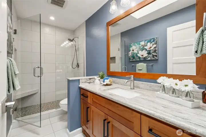 This is the updated main bathroom with its quartz counters and maple cabinets.