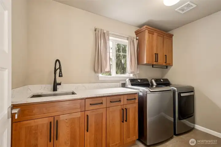 Even the upstairs utility room was updated with its quartz counters and the washer and dryer stay!