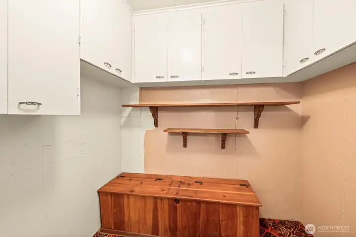 Storage abounds in the potential mudd room.