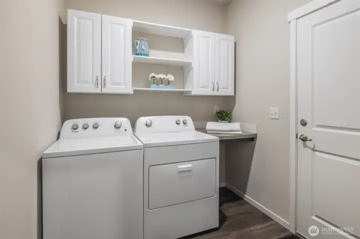 Laundry with added Cabinetry and shelves. Door to to garage