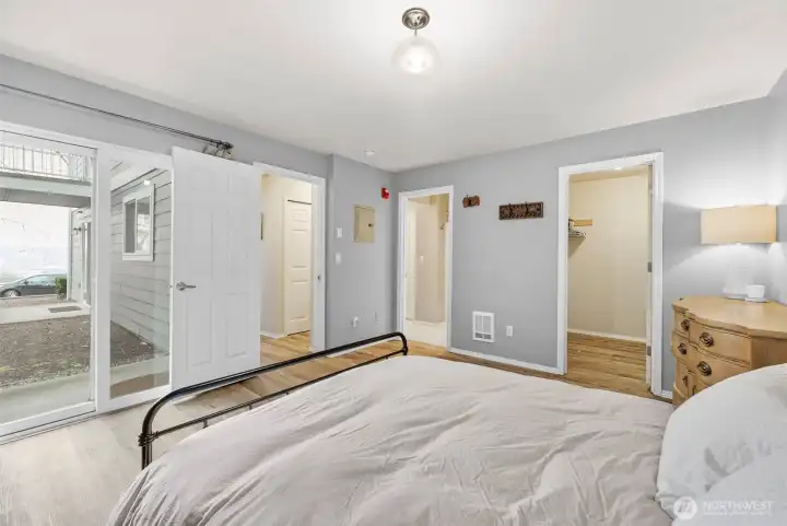 View to patio off primary bedroom, walk in closet and bathroom doorway.