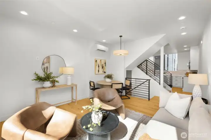 A secondary view of the expansive living area, emphasizing the rich hardwood floors and airy, open layout