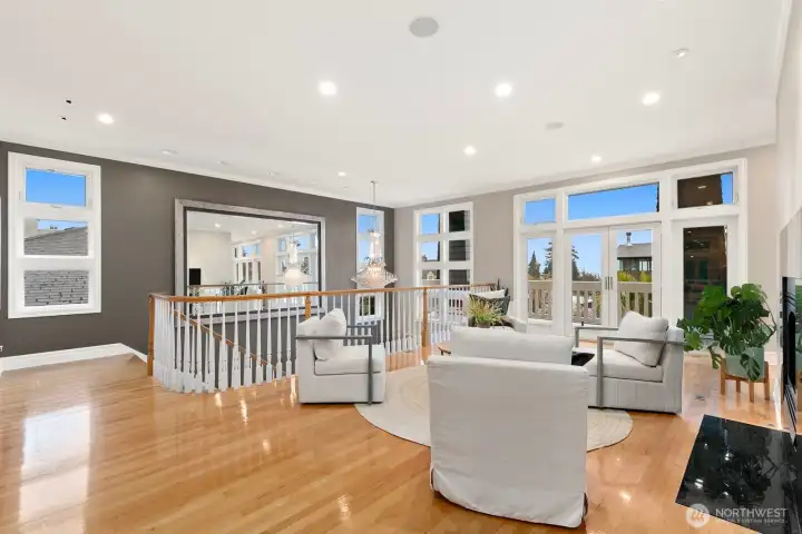 Upon entering the living level, you'll find this beautiful sitting room with walls of west-facing windows. The natural light in this home is truly stunning!