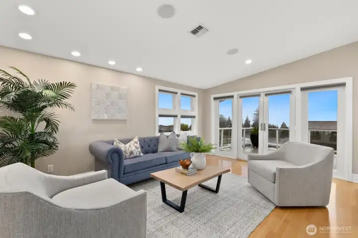 Head up to the primary/top level to yet another sitting room. The current owners spent most of their time here! The views are stunning and nearly 180 degrees. You can see the Sound, Olympic Mountains, and catch oh so many sunsets.