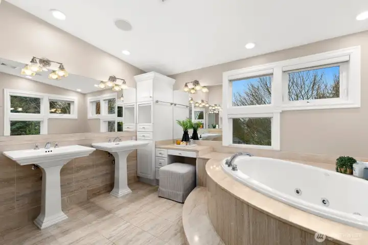 Primary 5-piece bath has extra storage as well as vanity seating.