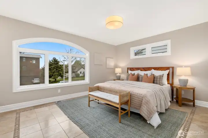 The third bedroom on this level is also considered the second primary suite. The largest bedroom has a desk nook off to the left in this photo and looks west. Two closets and it's own attached full bath!