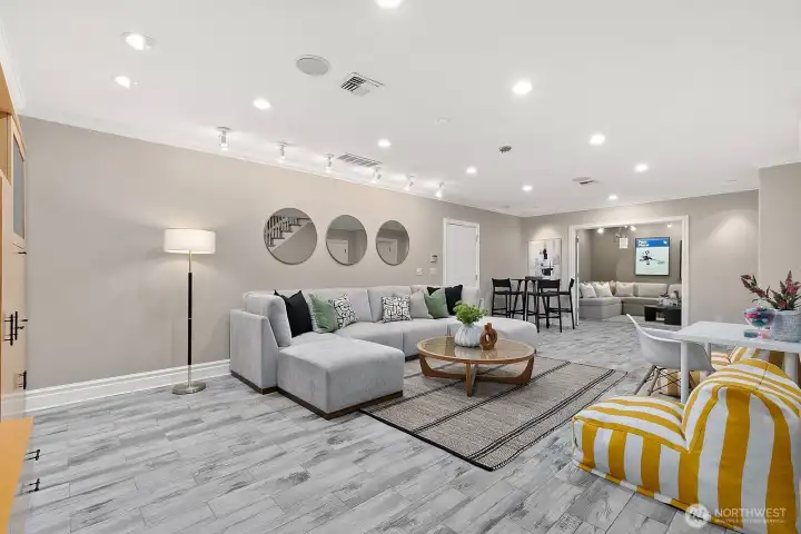 One the lower level, you'll find two more hang out spots. The first is the ideal rec room/flex space. There is a huge closet at the bottom of the stairs and the Elevator door is to the right  (not pictured). So you can park in the garage and walk right into the elevator just steps away!