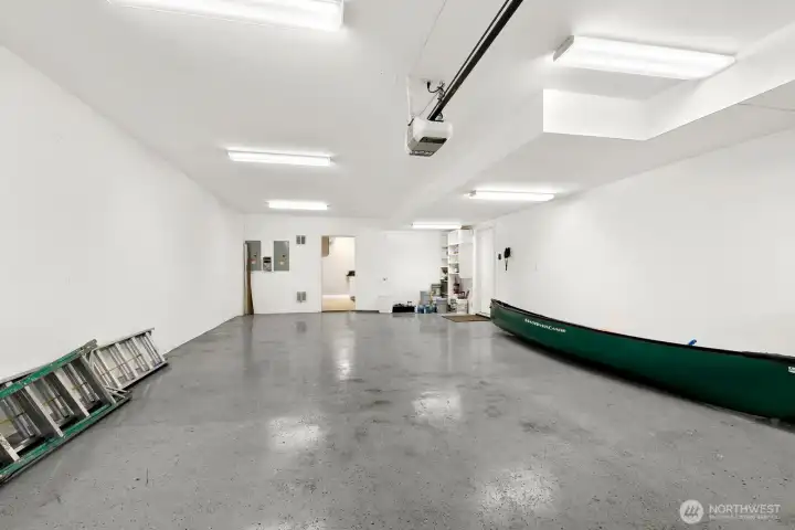 Attached four-car garage. You park two cars tandem, side-by-side. Note the storage and utility room at the back of the garage. Even more storage and the last laundry hook up!