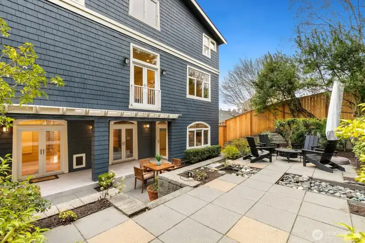The backyard has several patios and seating areas. The one just off of the back door is covered and recently tiled.