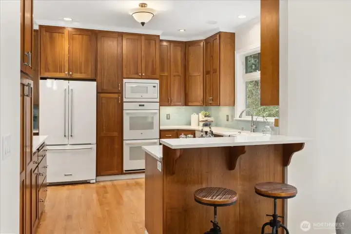 Enjoy the cherry wood shaker-style cabinets and white quartz counters