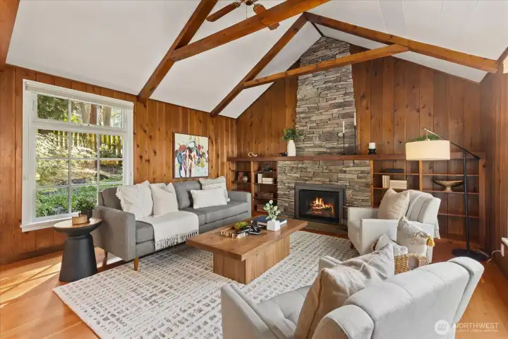 Notice the full height stone chimney facade and vaulted ceilings