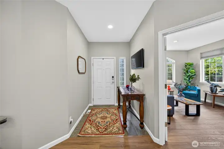 Entryway and a large office or den on the right through the French doors.