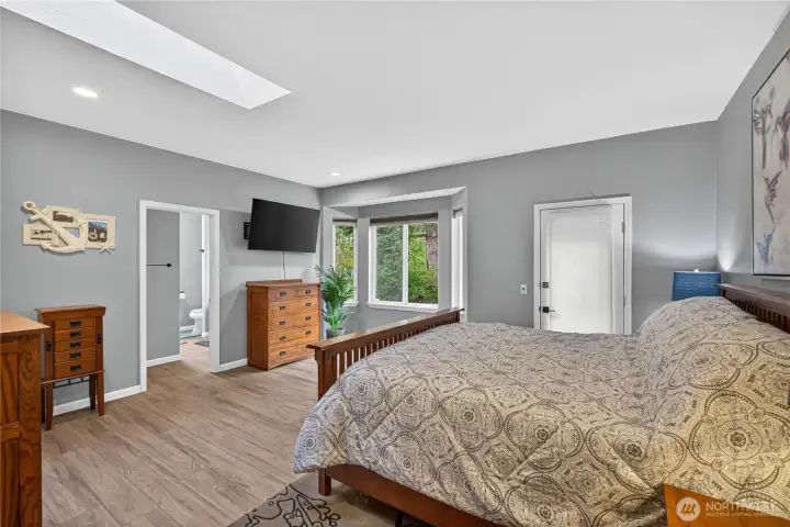 Primary Bedroom has space for your furniture, complete with a private deck through that door to the private. fenced. backyard patio.