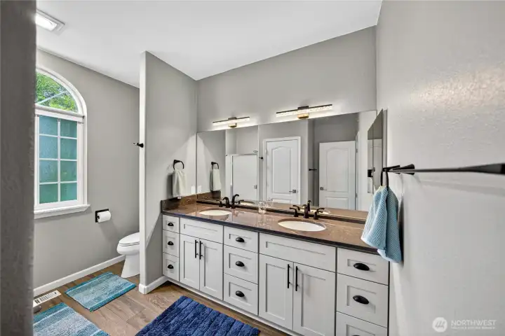 Primary Bathroom with brand new Quartz Countertops, new LVP flooring, fresh paint and new fixtures.