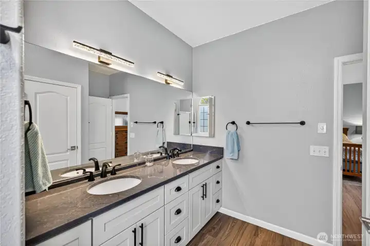 Primary Bathroom.  The new Quartz Countertop, fixturess and flooring look great!