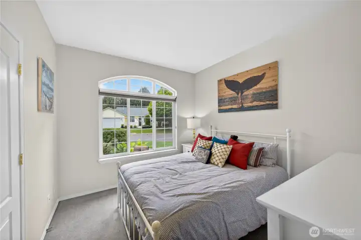 This is the first Guest Bedroom, first door on the right.  Huge Picture Window for lush garden viewing.