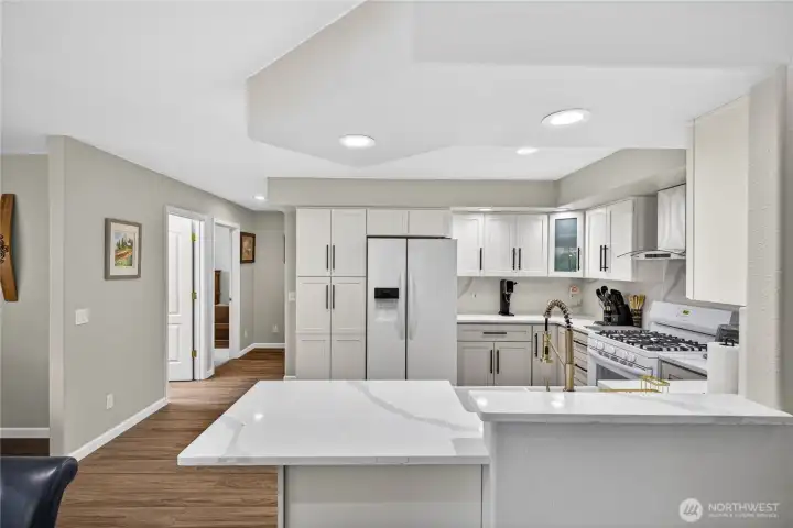 Who doesn't love a new, clean, white Kitchen?  New Quartz Countertops, Plumbing Fixtures, Stove Hood, Cabinets, Pantry Closet, LVP Flooring, Paint and more!