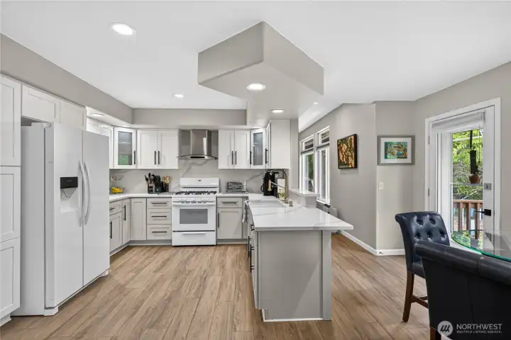 The new Pantry is on the left side of the Refrigerator. The door on the Right leads the newly fenced backyard and private sitting area.  The passageway on the right leads to the large Living Room space.