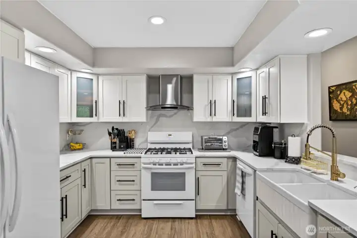 This photo of the Kitchen gives you a wonderful perspective with the double Farm Sink, all new cabinetry, pain. flooring, pantry, Stove Hood, and more!