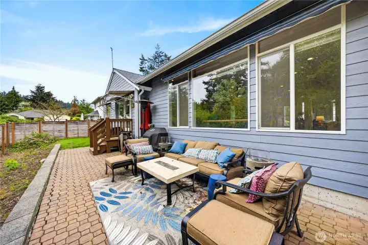 Here is a photo of the back yard before the brand-new fence was installed.  You can see the pavers and sitting area space.  The property is now Fully fenced for additional privacy.