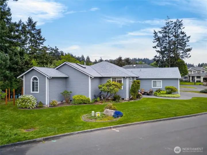 This home has wonderful street appeal.  There are Solar Panels on the other side of the Roof.   Those fence posts are now a fully completed fence with a gate at this end for access.