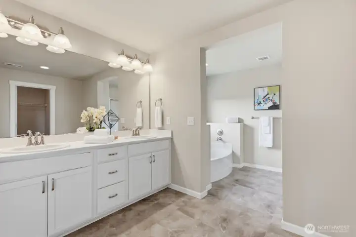 Spacious primary bath with dual vanity and soaking tub