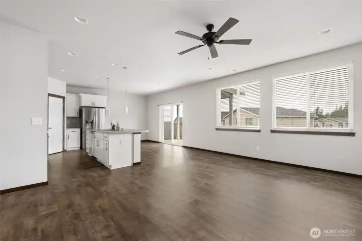 This is where the home opens up, with the kitchen, dining, and living spaces all connected so everyday meals, conversation, and time together can happen naturally.