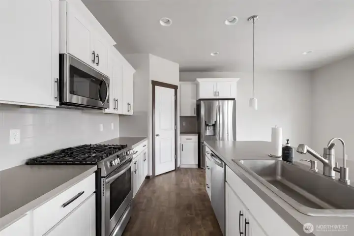 This side of the kitchen gives the small routines their own place, from the morning coffee setup to pantry storage that keeps the counters clear and the day moving smoothly.