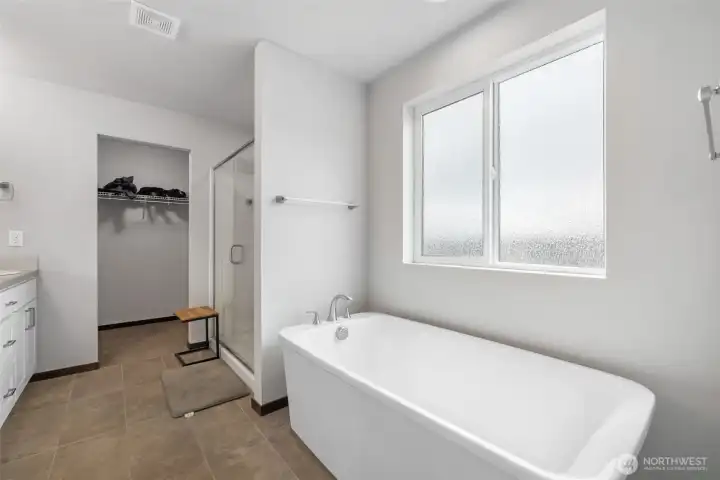 This is where the primary suite adds a little daily luxury, with space to soak, rinse, get ready, and keep the closet close enough that mornings can feel less like a scavenger hunt.