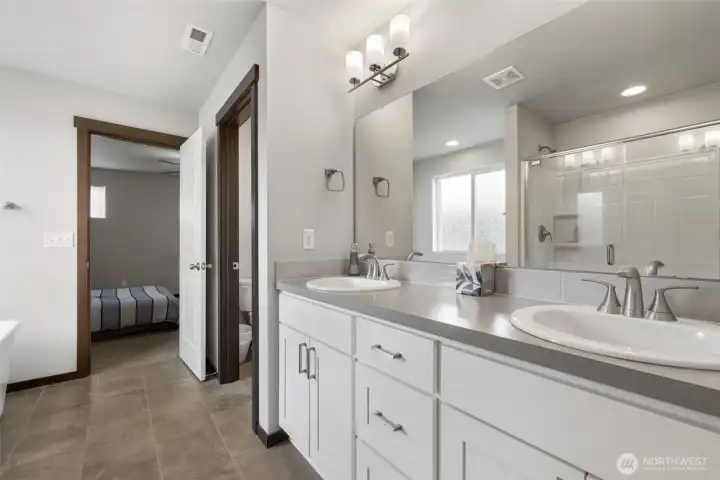 Two sinks, generous counter space, and a smart bath layout make busy mornings feel less crowded and feel a little more civilized.