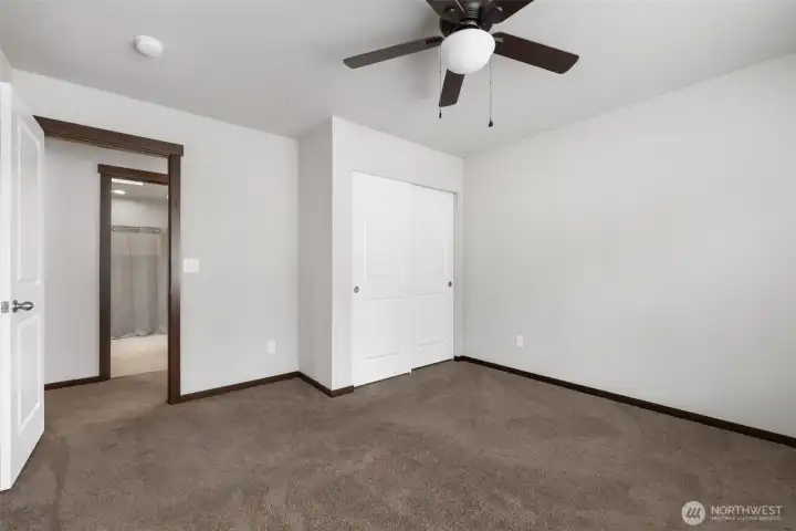From this angle, the room starts to feel more useful than empty, with closet storage, easy access to the nearby bath, and enough flexibility to become the space your life actually needs.