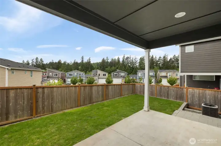 This backyard hits the sweet spot: enough room for fresh air, pets, plants, and a few chairs under cover, without turning your weekends into yard duty.