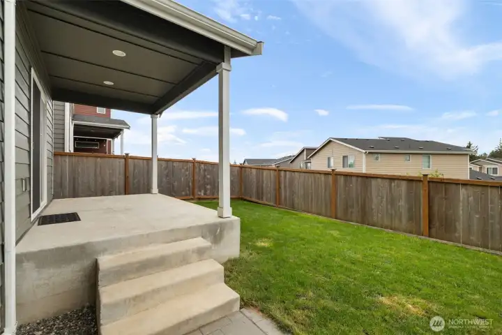 The fencing gives the backyard a comfortable sense of enclosure, creating a calm little outdoor pocket where you can enjoy the neighborhood setting without feeling exposed.