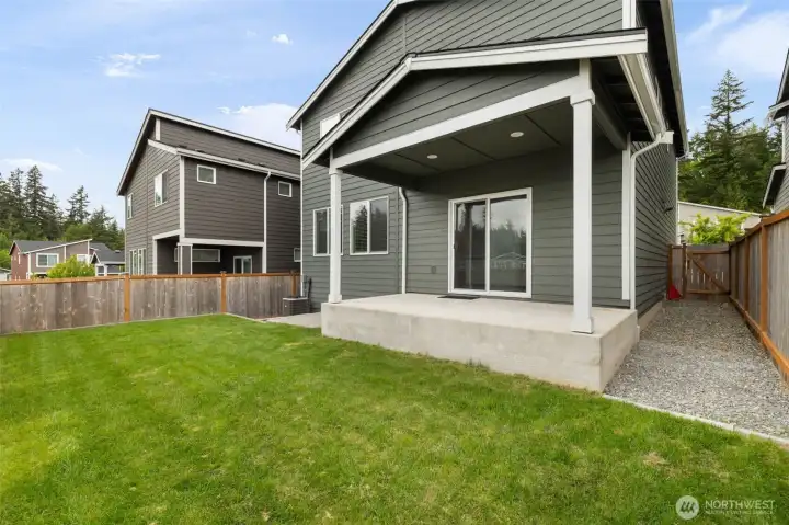 The backyard feels nicely contained and easy to enjoy, with fencing that creates a comfortable outdoor pocket and a sprinkler system to help keep the lawn looking good with less effort.