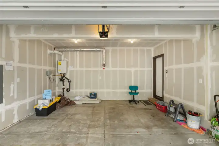 The garage is not just parking. It gives you practical storage, room to move, and a wall mounted tankless water heater that helps keep more of the space usable.