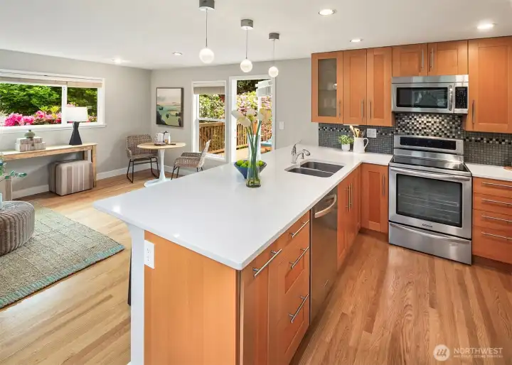Updated kitchen with quartz counters, stainless steel appliances and access to deck and yard.