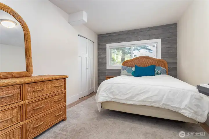 Bedroom with closet and egress window in daylight basement. Bedroom with closet and egress window in daylight basement.