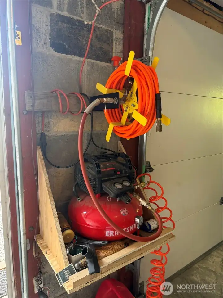 Air compressor and generator and propane tank in the garage conveys. Air compressor and generator and propane tank in the garage conveys.