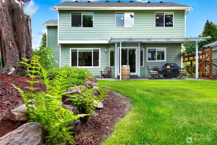 Lush landscaping surrounds this home Lush landscaping surrounds this home